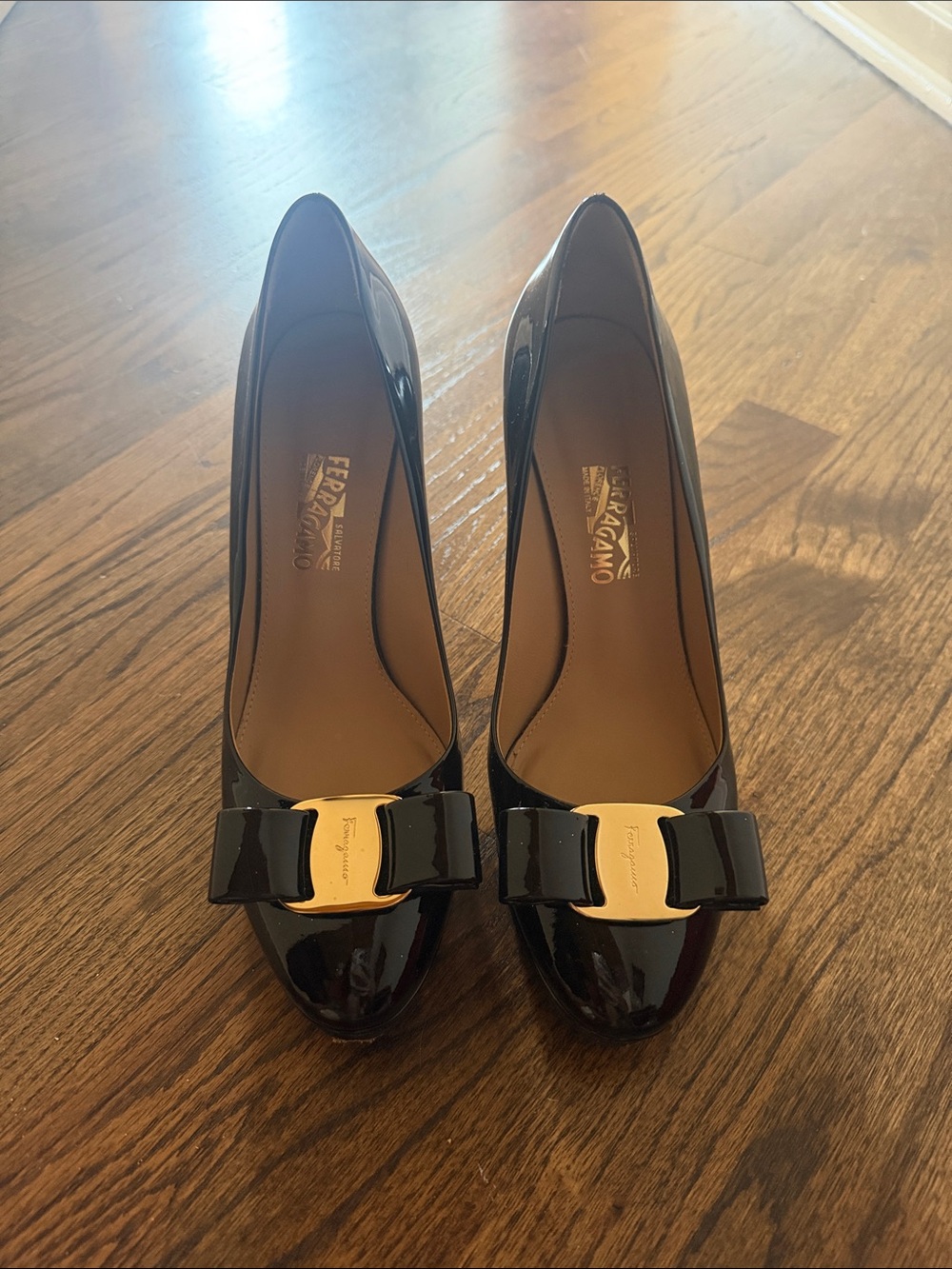 Salvatore Ferragamo Black Patent Vara Bow Pumps with Gold Plaque Accent